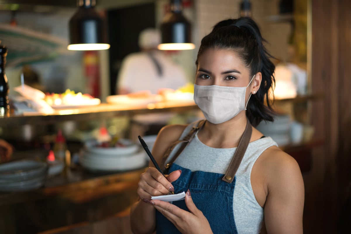 Business owner working at a cafe wearing a facemask - small -1224667653